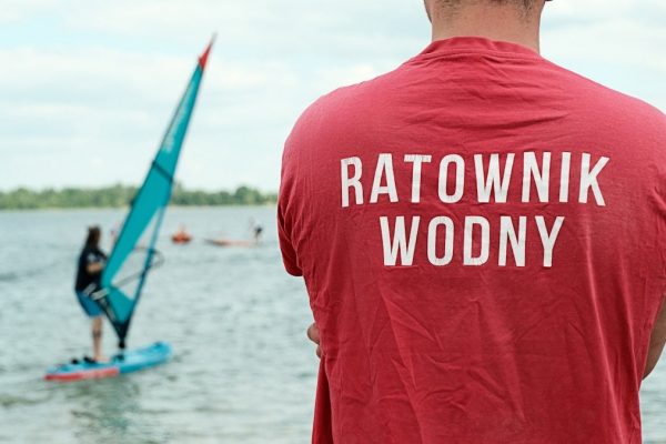 Water rescue lifeguard watching over Pogoria III lake during a summer watersports day in Poland.
